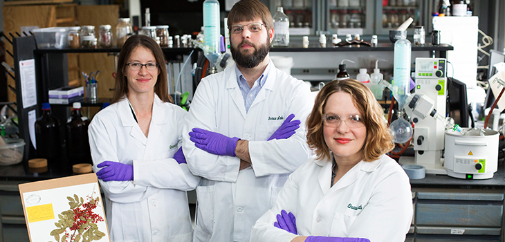 three scientists in lab coats