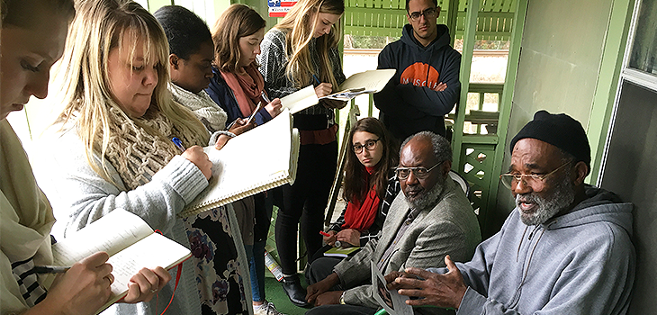 Group of people writing in notebooks