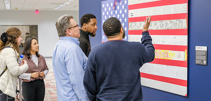 Teaching fellows reviewing an exhibit